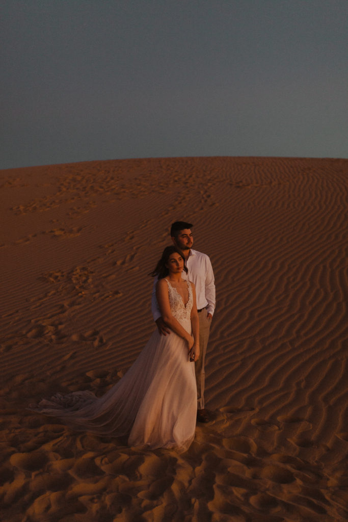 bride and groom at imperial sand dunes during sunset